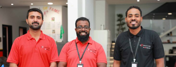 Three men who work together posing for a picture.